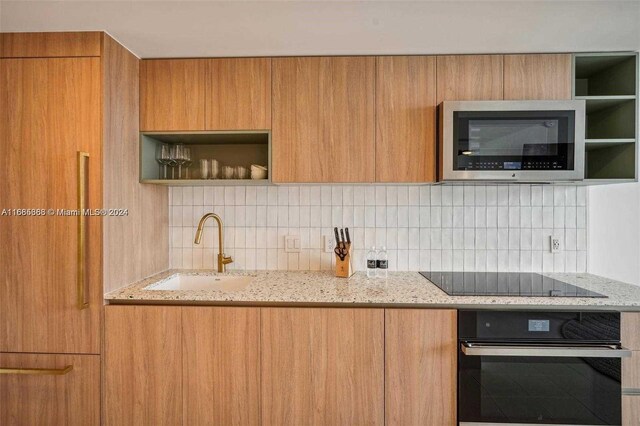 601 Ne 1st 4114, Miami, FL 33132 - kitchen with black appliances, a sink, open shelves, backsplash, and modern cabinets