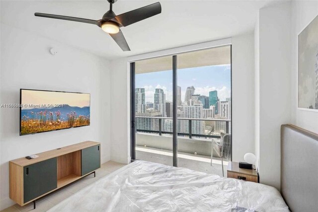 601 Ne 1st 4114, Miami, FL 33132 - bedroom featuring access to exterior, a view of skyline, expansive windows, light tile patterned floors, and a ceiling fan
