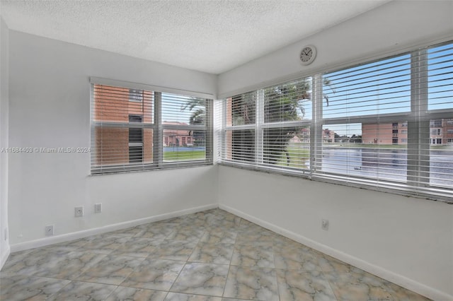 empty room with a textured ceiling