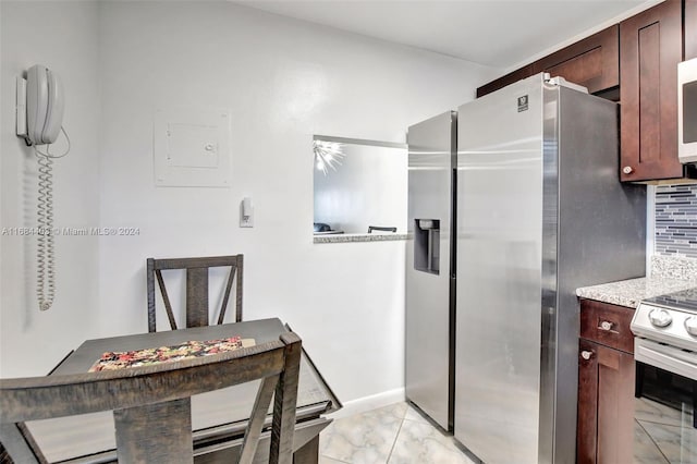 kitchen featuring appliances with stainless steel finishes, decorative backsplash, and electric panel