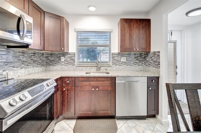 kitchen featuring appliances with stainless steel finishes, sink, plenty of natural light, and decorative backsplash