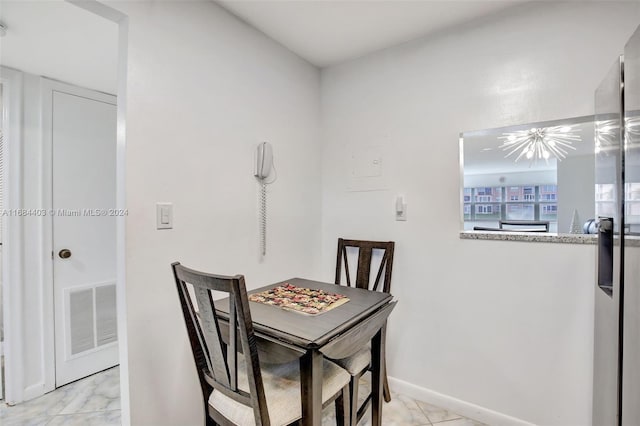 dining space featuring a notable chandelier