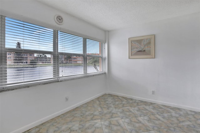 spare room featuring a textured ceiling