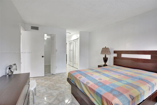 bedroom featuring a closet and a textured ceiling