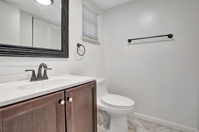 bathroom featuring toilet and vanity