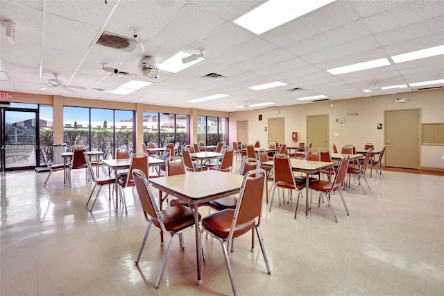 dining area featuring a drop ceiling and ceiling fan