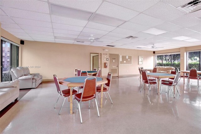 dining room with a drop ceiling and ceiling fan