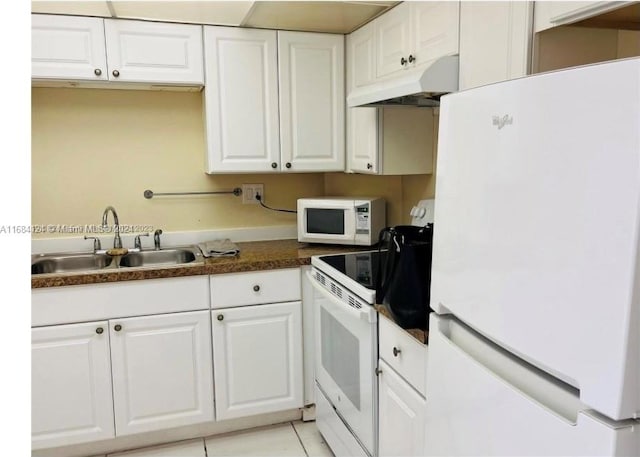 kitchen featuring white appliances, white cabinetry, sink, and premium range hood