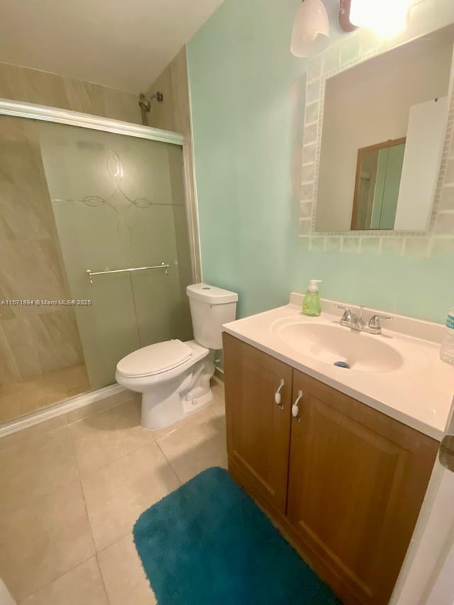 4046 Eastridge Dr, Deerfield Beach, FL 33064 - bathroom featuring vanity, tile patterned floors, toilet, and a stall shower