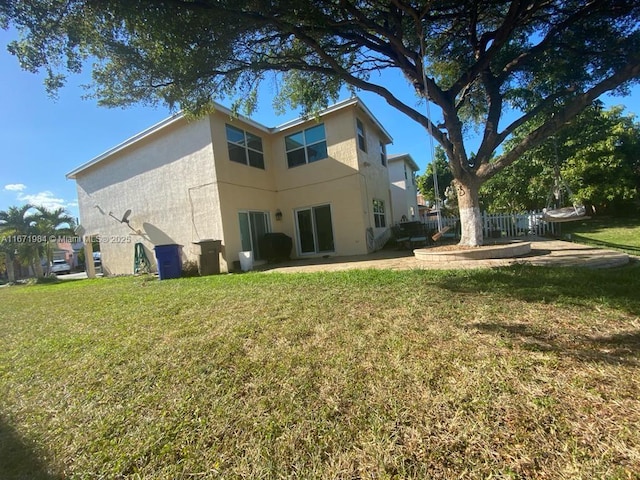 4046 Eastridge Dr, Deerfield Beach, FL 33064 - back of property featuring a lawn, a patio, and stucco siding