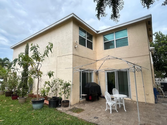 4046 Eastridge Dr, Deerfield Beach, FL 33064 - back of property featuring a patio area and stucco siding