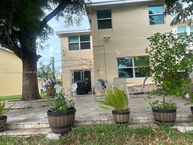 back of house with a patio