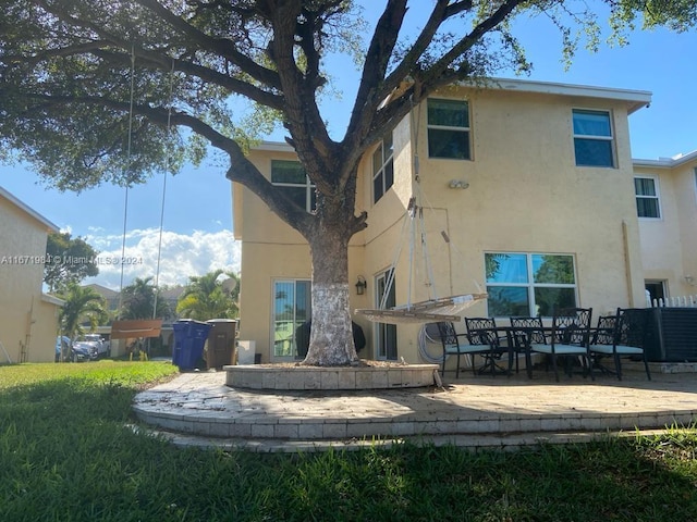 rear view of property featuring a patio area