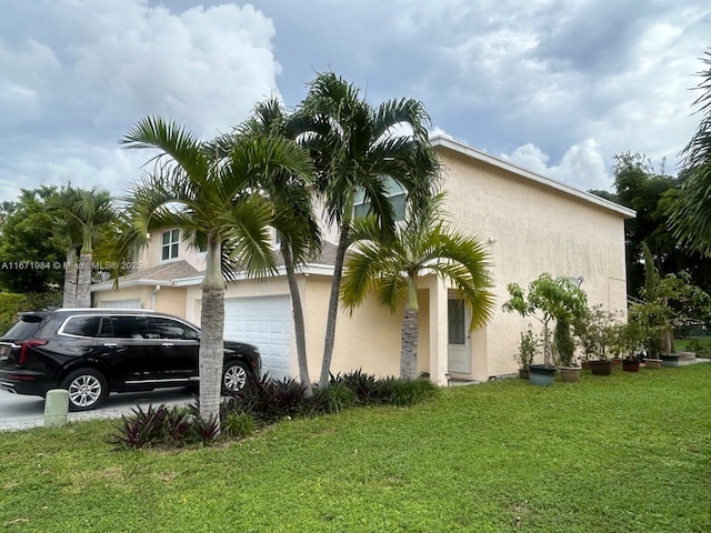 4046 Eastridge Dr, Deerfield Beach, FL 33064 - view of side of property with stucco siding, a lawn, and a garage