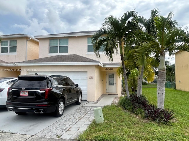 view of front of property featuring a garage and a front lawn