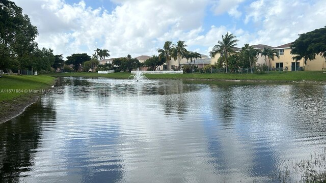 view of community featuring a lawn and a water view