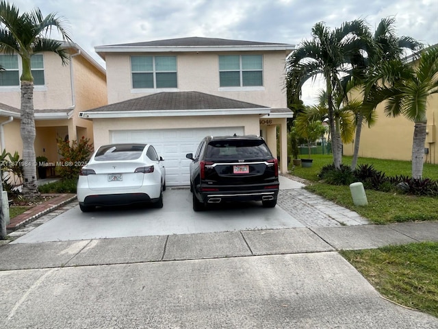 4046 Eastridge Dr, Deerfield Beach, FL 33064 - view of front of house with stucco siding, an attached garage, concrete driveway, and a shingled roof