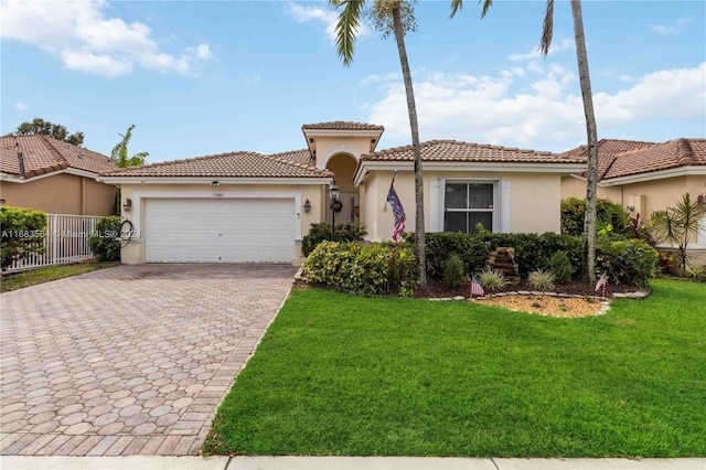 mediterranean / spanish-style home with a front yard and a garage