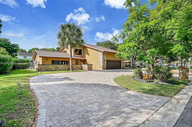 view of front of home featuring a garage and a front lawn