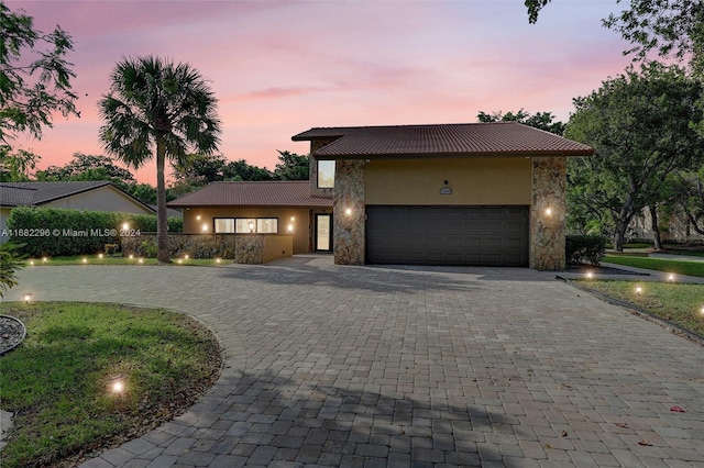 view of front of home featuring a lawn and a garage