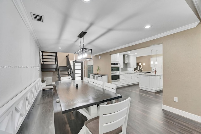 dining space featuring crown molding and dark wood-type flooring