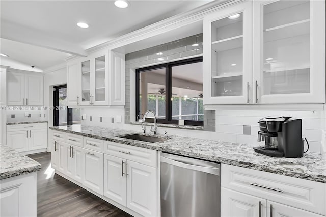 kitchen with sink, dishwasher, dark hardwood / wood-style floors, light stone counters, and white cabinets