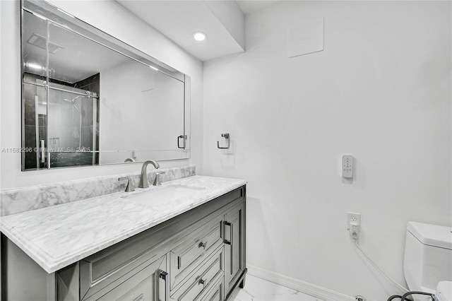 bathroom with vanity, an enclosed shower, and toilet