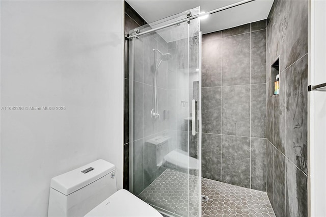 bathroom with an enclosed shower and toilet