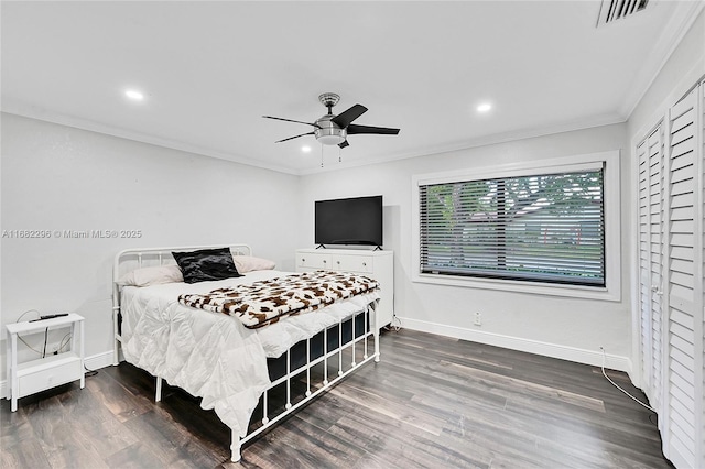 bedroom with crown molding, dark wood-type flooring, and ceiling fan