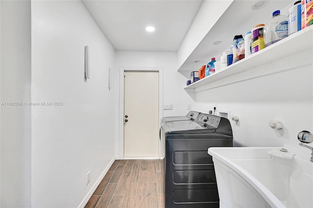 washroom featuring washing machine and dryer and sink