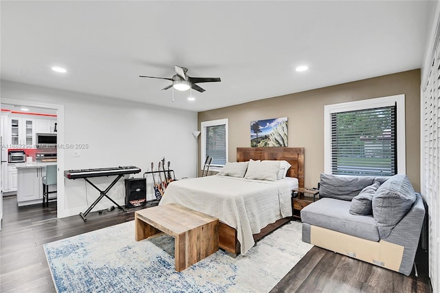 bedroom with dark hardwood / wood-style flooring and ceiling fan