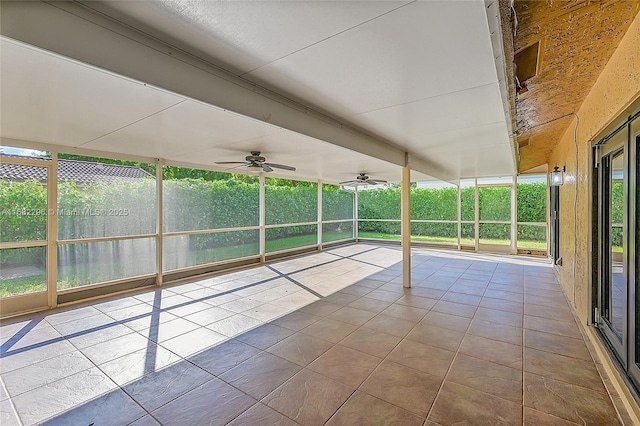 unfurnished sunroom with ceiling fan