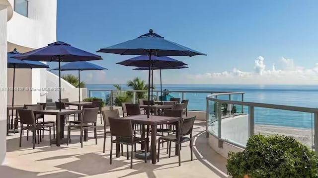 balcony with a water view and a beach view