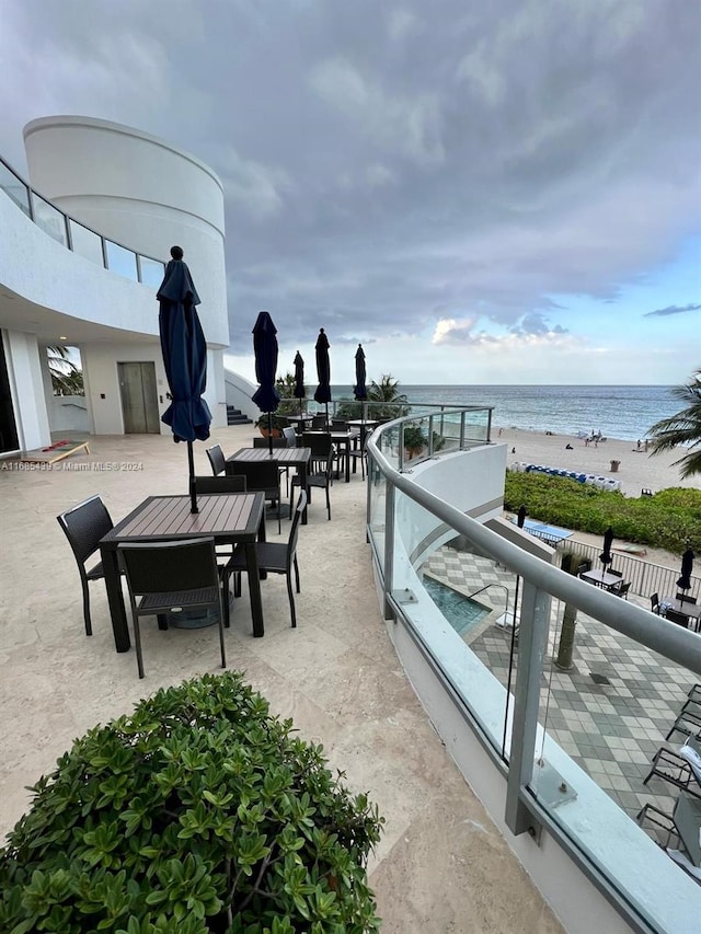 view of patio with a view of the beach and a water view