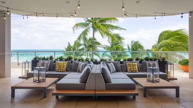 view of patio featuring an outdoor hangout area, a water view, and a balcony