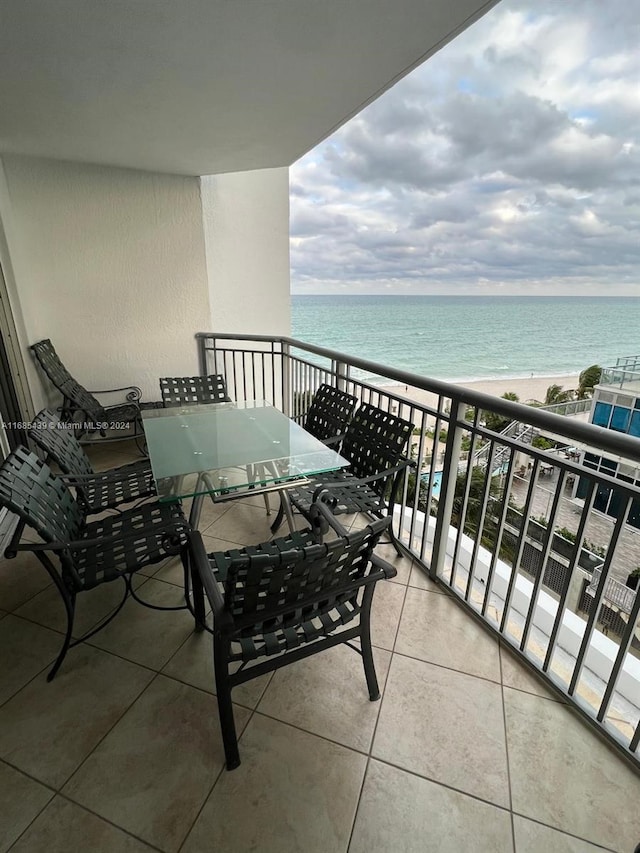 balcony featuring a water view and a view of the beach