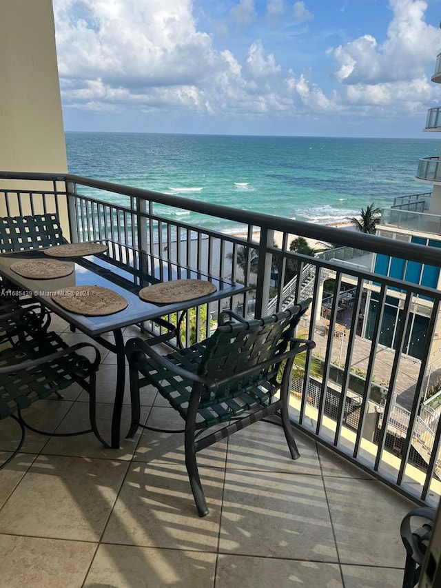 balcony with a water view and a beach view