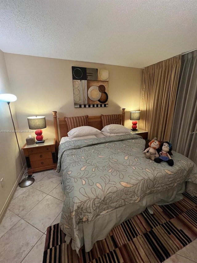 tiled bedroom featuring a textured ceiling