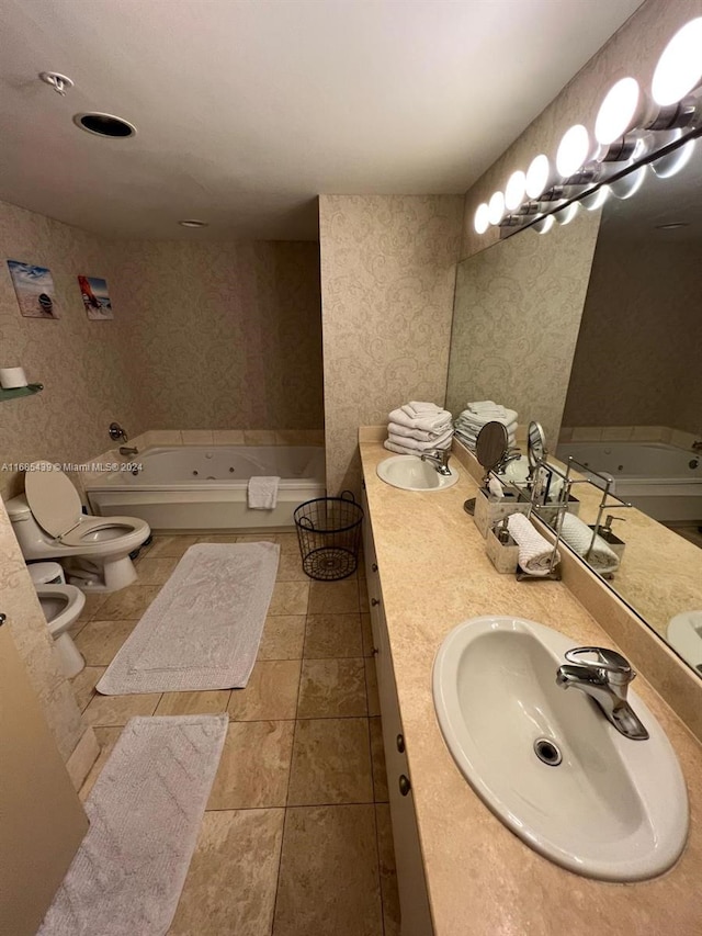 bathroom featuring a bathing tub, tile patterned floors, a bidet, toilet, and vanity