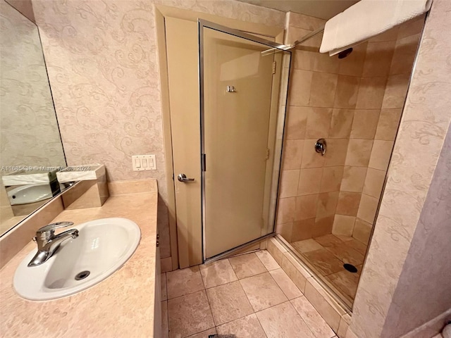 bathroom with vanity and a shower with shower door