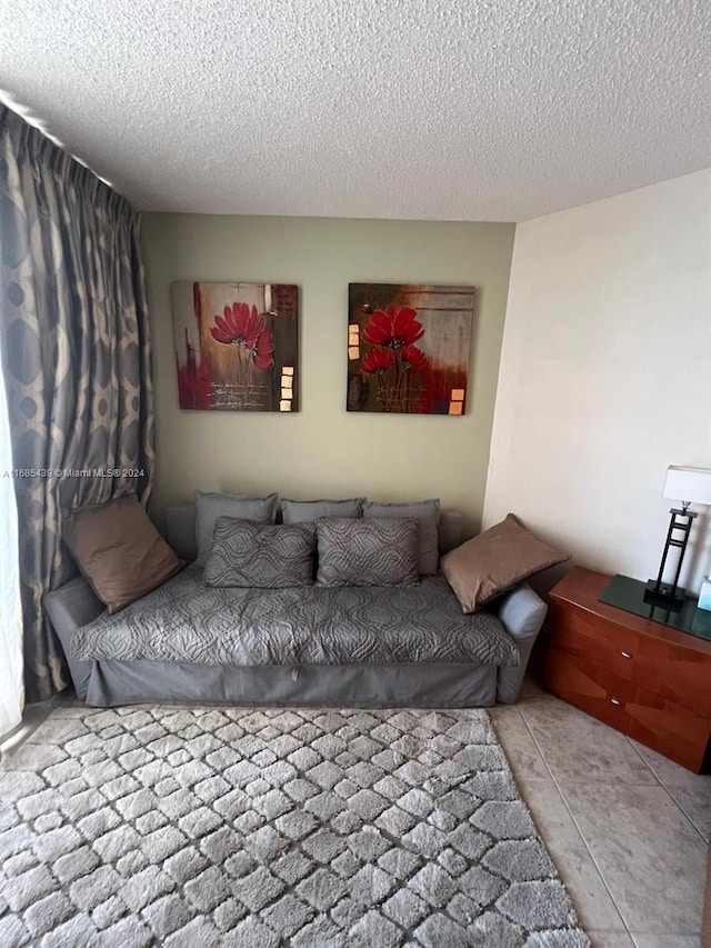 bedroom featuring light tile patterned flooring and a textured ceiling