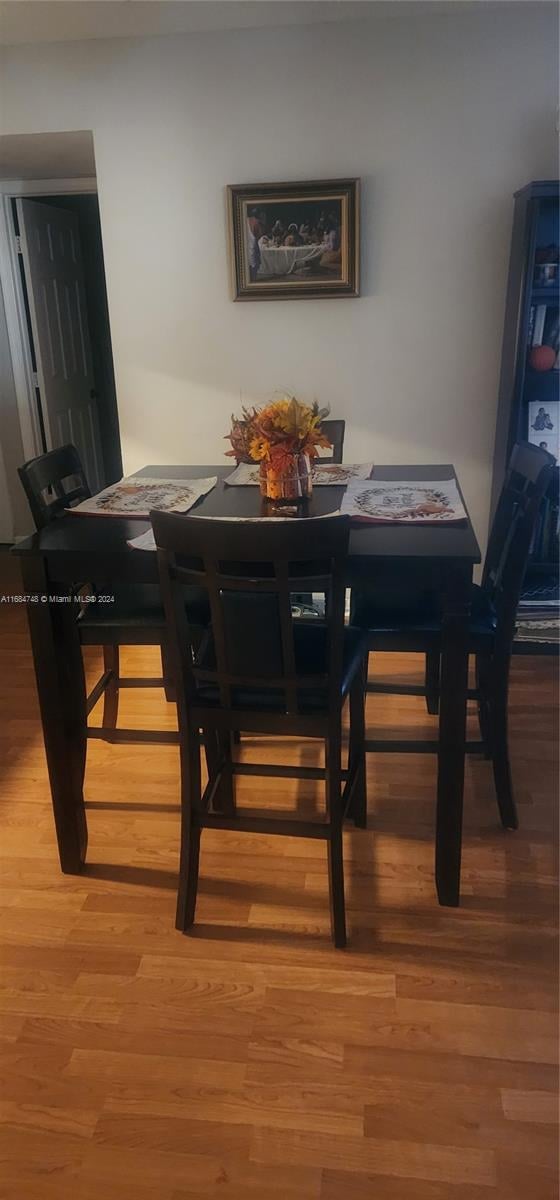 dining area with hardwood / wood-style flooring