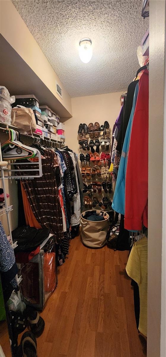 walk in closet featuring hardwood / wood-style floors