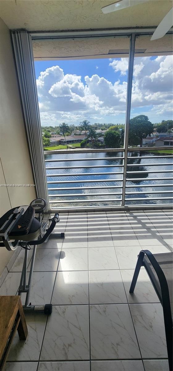 view of patio / terrace with a water view and a balcony