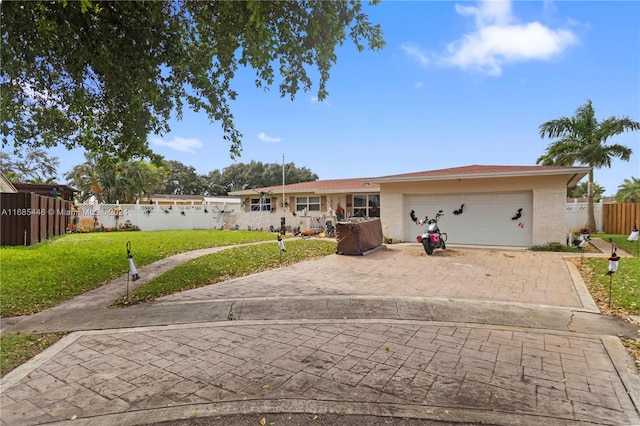 single story home with a front yard and a garage