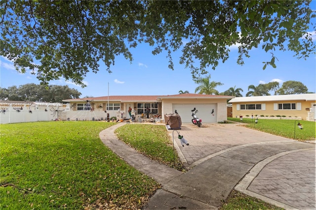 ranch-style house with a front yard and a garage