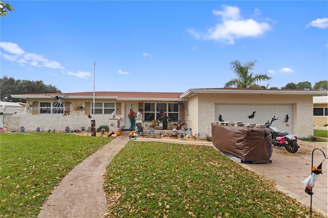 ranch-style home with a front yard and a garage