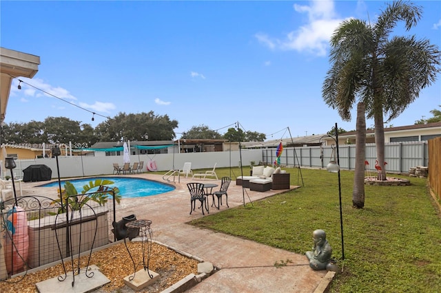 view of swimming pool featuring a patio and a yard