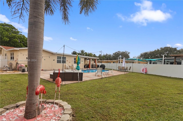 view of yard with a patio, a fenced in pool, and an outdoor hangout area