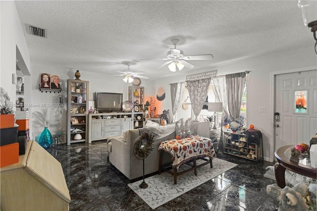 living room featuring a textured ceiling and ceiling fan